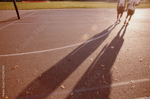 Obraz Sunset, two young basketball players