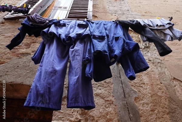 Obraz Blue work clothes hanging after washing