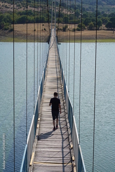 Obraz Man, walk on a ragged rope bridge