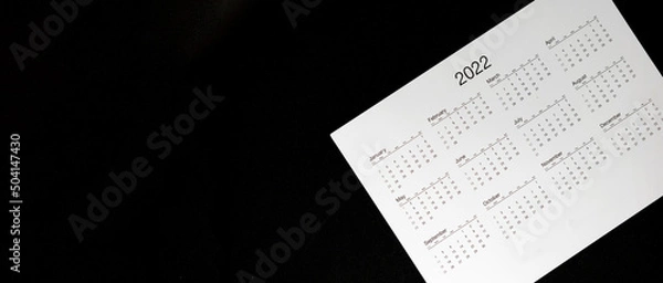 Fototapeta Close up 2022 calendar with banner size and copy space black background, schedule arrangement and manage appointment, timetable, timeline, planner agenda and payment reminder in advance