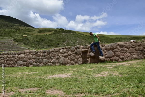 Fototapeta A person on the territory Inca terraces of Moray. Moray is an archaeological site near the Sacred Valley
