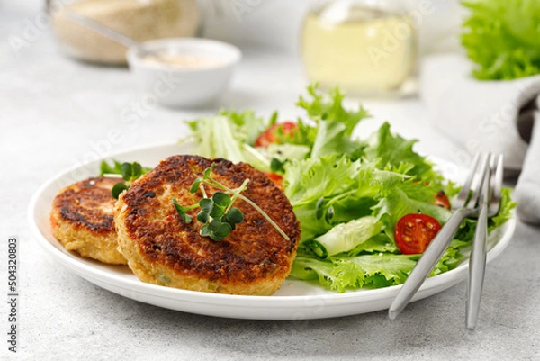 Obraz Dinner lunch concept. Quinoacutlets served with lettuce, tomatoes, microgreens. Diet food, close up