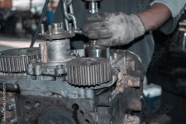 Fototapeta The mechanic is checking the engine.