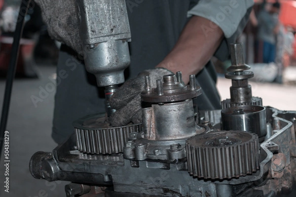 Fototapeta The mechanic is checking the engine.