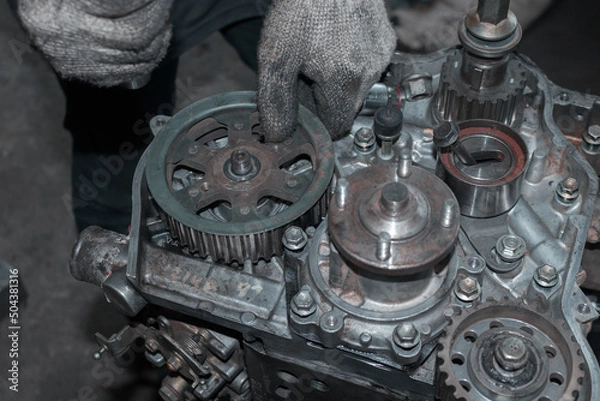 Obraz The mechanic is checking the engine.