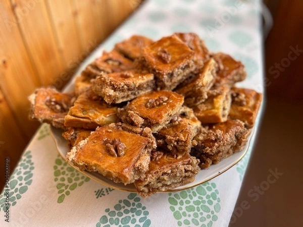 Fototapeta Pakhlava is a sweet of pastry, nuts and honey popular across the Caucasus, Middle East and eastern Mediterranean. Baclava is usually cut in the form of rectangles