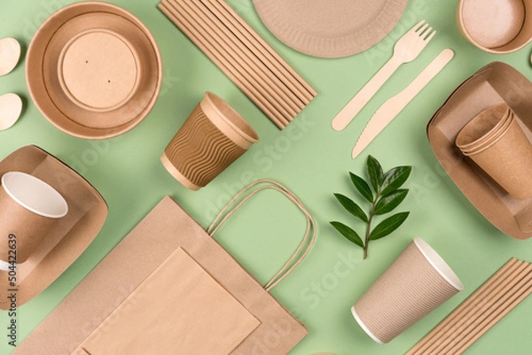 Obraz Eco-friendly tableware - kraft paper food packaging on light green background. Street food paper packaging, recyclable paperware, zero waste packaging concept. Flat lay