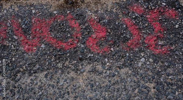 Fototapeta Red spray painted markings on pavement grunge texture