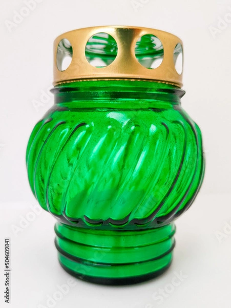 Fototapeta An unquenchable lamp made of green glass. Candle for the grave with a lid. A memorial candle. A memory candle.