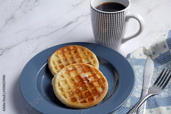 Obraz Waffles with butter and syrup, and coffee for breakfast.