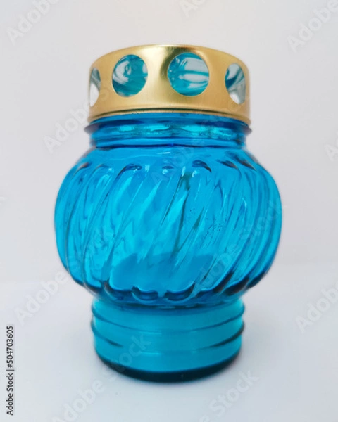 Fototapeta An unquenchable lamp made of blue glass. Candle for the grave with a lid. A memorial candle. A memory candle.