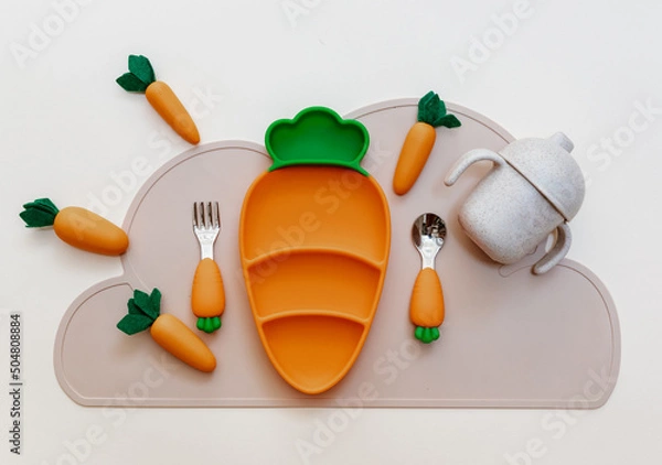Obraz Top view modern silicone dishware plate and spoon. Serving baby, first feeding concept. Kids tableware. Flat lay, copy space, top view