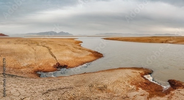 Obraz The shore of the Krasnoyarsk reservoir without water, sandy ripples, clay and hills, rainy sky over Mount Tepsey Tepsei