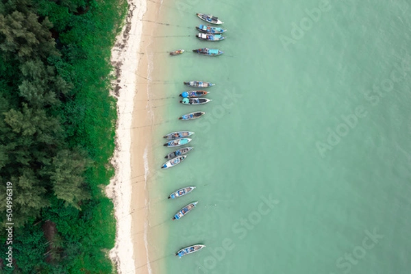 Fototapeta Fisherman long tail boat at shore beach aerial top view greenery tree blue sea