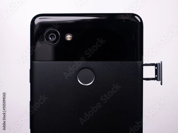 Fototapeta SIM tray for SIM card in smartphone close-up view on a white background