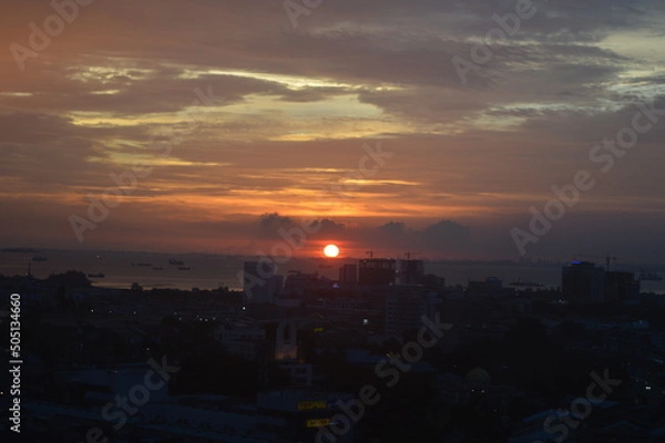 Fototapeta Sunset view in the middle of the city