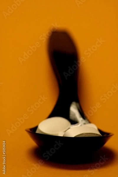 Obraz Pills in a black plastic spoon