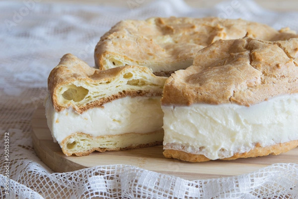 Obraz Traditional Polish cake Karpatka on light textile background. Cake of choux pastry dough and custard cream. Carpathian cake. Selective focus