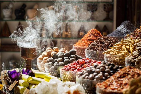 Obraz Arabic traditional incense bukhoor agar wood burner with the smoke, used in majlis, Ramadan and Eid in the spice market in Dubai