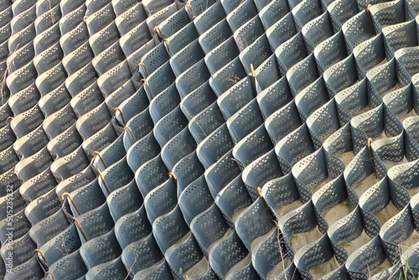 Fototapeta Polymer geogrid is not filled with soil. Strengthening the slope with a special grid