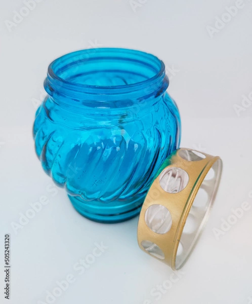 Fototapeta An unquenchable lamp made of blue glass. Candle for the grave with a lid. A memorial candle. A memory candle.