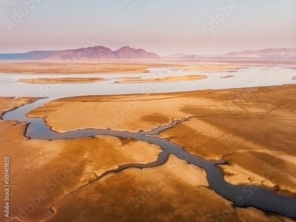 Obraz The shore of the Krasnoyarsk reservoir without water, sandbanks, clay and hills, riverbeds and channels, rainy sky over Mount Tepsey Tepsei
