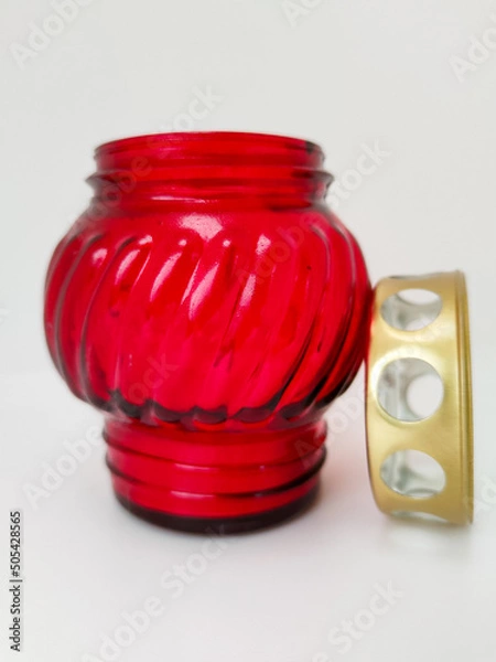 Fototapeta An unquenchable lamp made of red glass. Candle for the grave with a lid. A memorial candle. A memory candle.