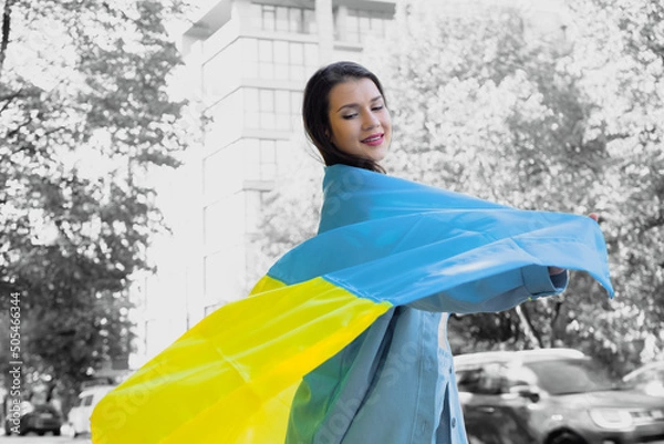 Obraz Smiling girl with Ukrainian flag. War in Ukraine