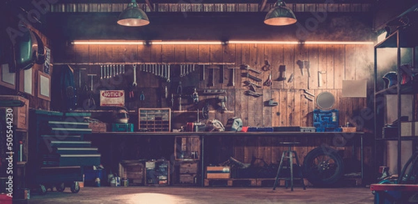 Fototapeta Workshop scene. Old tools hanging on wall in workshop, Tool shelf against a table and wall, vintage garage style