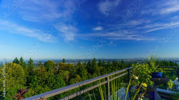 Fototapeta Panoramic summer view of BC Lower Mainland with Straits of Georgia and Gulf Islands on far horizon as seen from a Burnaby Mountain rooftop patio garden.