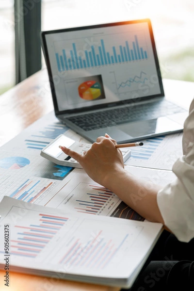 Fototapeta businesswoman working at office with document on her desk, doing planning analyzing the financial report, business plan investment, finance analysis concept.