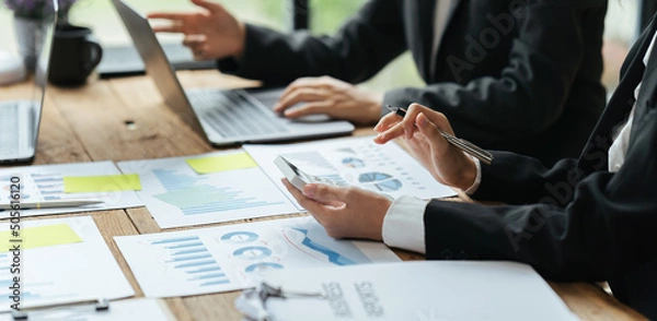 Fototapeta Teamwork with business people analysis cost graph on desk at meeting room, business team briefing plan. creative startup business people group in office.