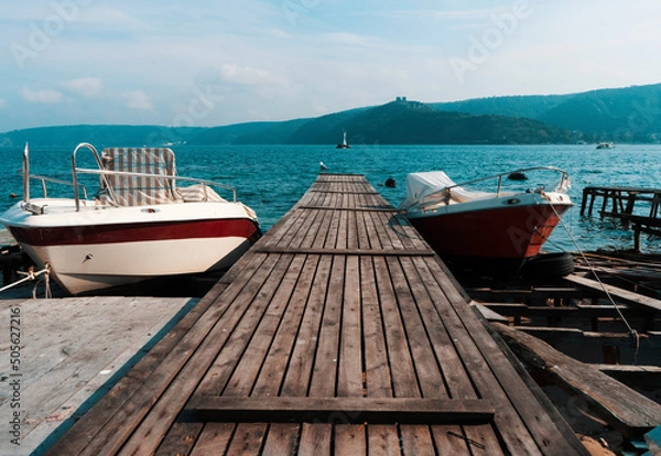 Fototapeta A pier and two boats beside, view from European side of the Istanbul to Asian side of Istanbul at Rumeli Kavağı,Sarıyer.