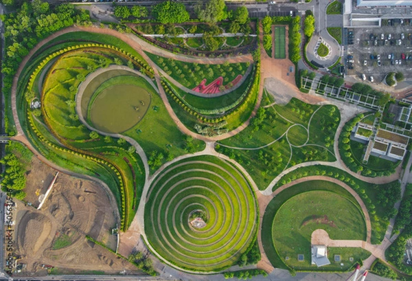 Obraz Aerial view of Parco del Portello in Milan, near CityLife, Lombardia. View from the height of park with a green lawn and paths. Abstract design similar to a dragon. Drone photography in Milano.
