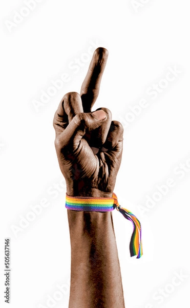 Fototapeta Black hand wearing a bracelet with the colors of the LGBT flag showing the middle finger as a symbol of protest. LGBT symbol.