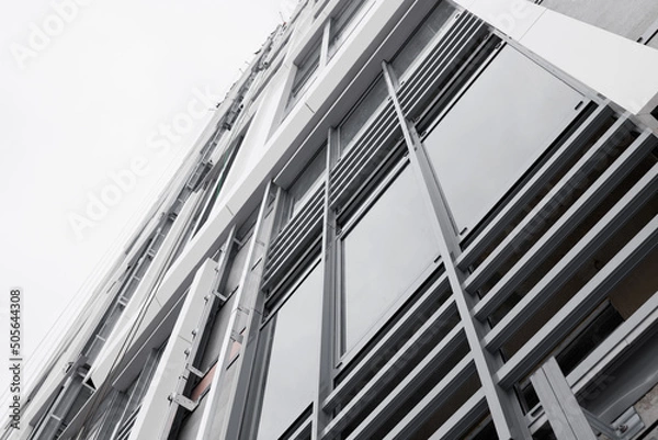 Fototapeta The system of fixing the facade on the building. Aluminum decorative profiles on the building. Modern architectural solutions. Ventilated facade with stone wool insulation and ceramic tiles