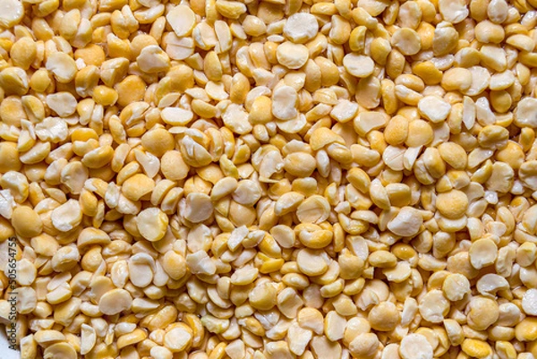 Obraz Yellow, dried peas scattered background. Food backdrop.