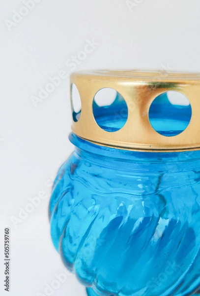 Fototapeta An unquenchable lamp made of blue glass. Candle for the grave with a lid. A memorial candle. A memory candle.