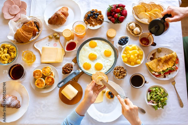 Obraz Cheesecakes on a white table. Cheesecakes with berries and honey. Beautiful breakfast. Food day. Dinner. Buffet. Breakfast on the table top view.Food on the table top view.Muesli with berries. Fried 