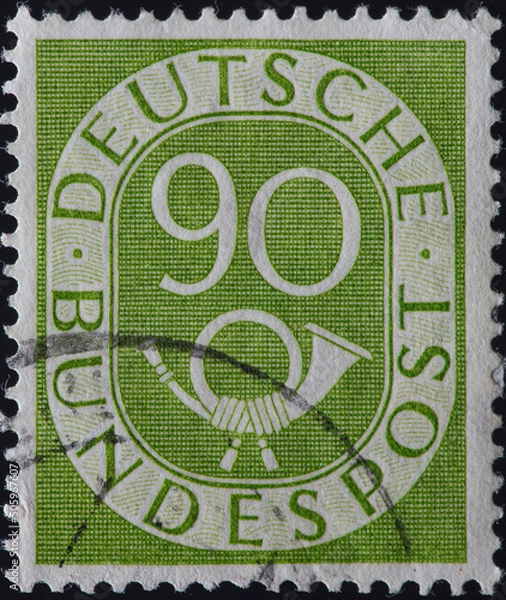 Fototapeta GERMANY - CIRCA 1951: a postage stamp from GERMANY, showing a permanent stamp numerals in the oval and posthoorn. Text: Deutsche Bundespost. Circa 1951