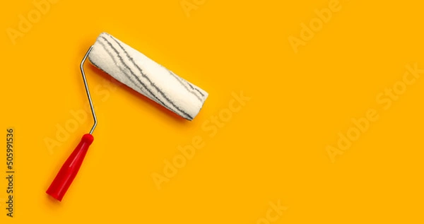 Obraz Paint roller isolated on orange background.