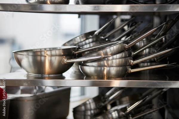 Obraz frying pans in a stack on a shelf 