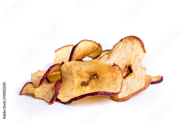 Fototapeta Dehydrated apple slices with cinnamon and sugar sprinkles over white.