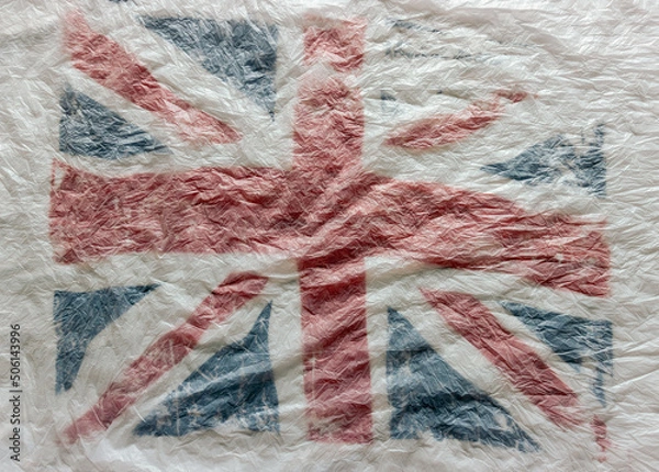 Fototapeta Textured background of the British flag in white, red and blue national colors. blur, defocus.