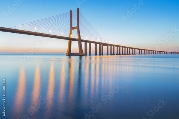 Fototapeta Background on the Lisbon bridge. The Vasco da Gama Bridge is a landmark, and one of the longest bridges in the world. Urban landscape. Portugal is an amazing tourist destination