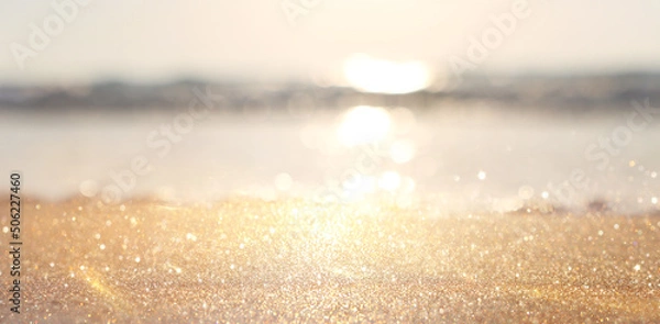 Fototapeta Sea waves and warm sunset light, calm and relaxing sandy beach