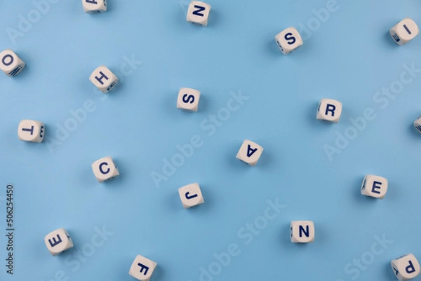 Obraz  cubes or blocks word with letters randomly on a blue background - the concept of a newborn boy, school education or self education 