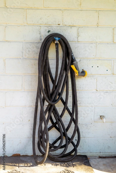 Obraz Water hose hanging on wall