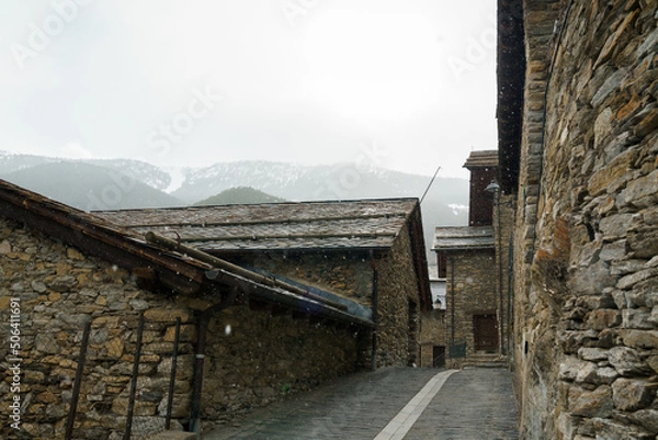 Fototapeta Pal, La Massana, Andorra. April 2022. Beautiful high mountain town. On a cold, snowy day in early spring.