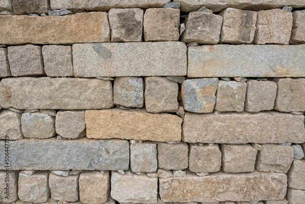 Fototapeta Arrangement and texture of stone walls